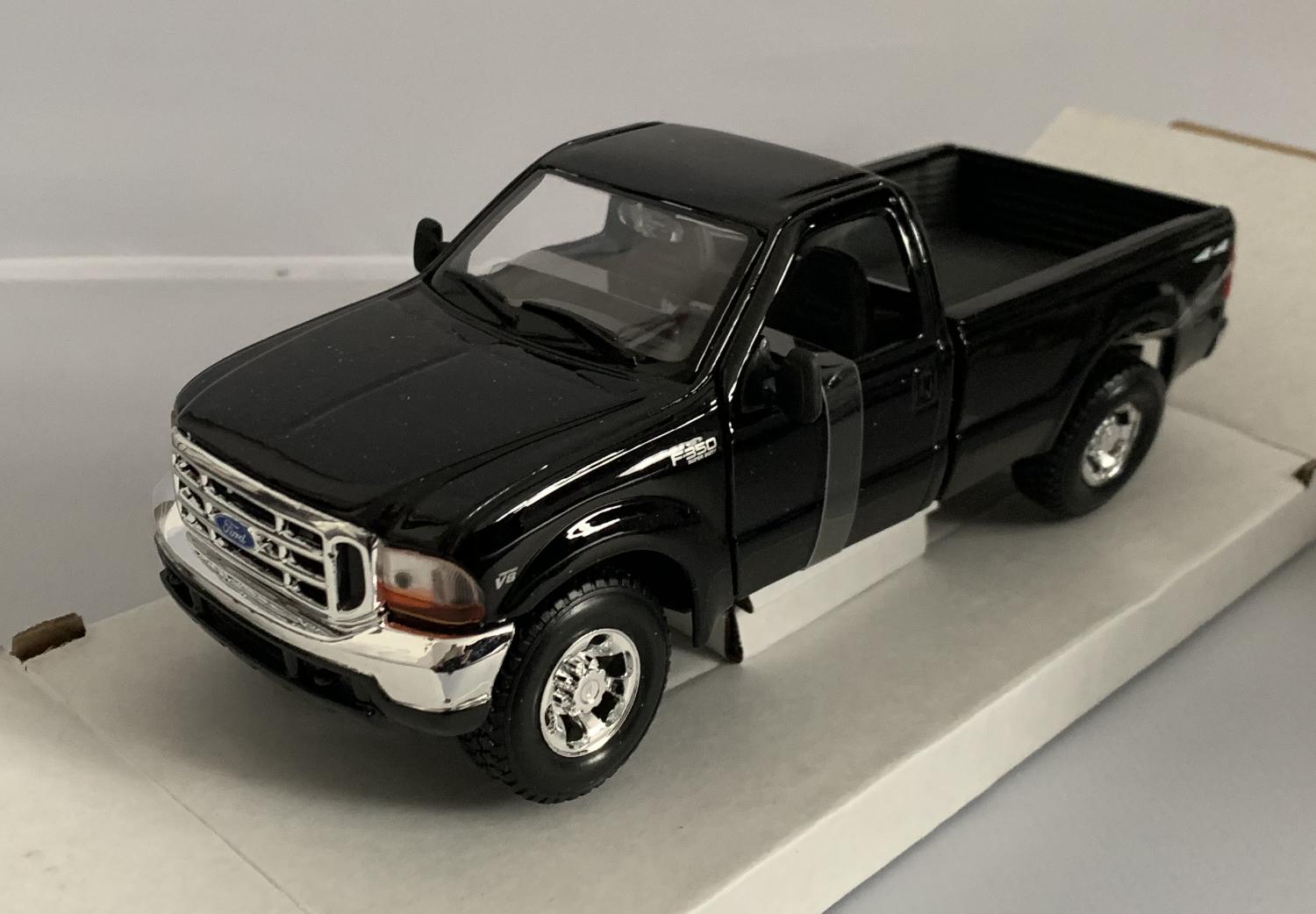 An excellent scale model of a Ford F-350 Super Duty Pickup decorated in black with chrome wheels