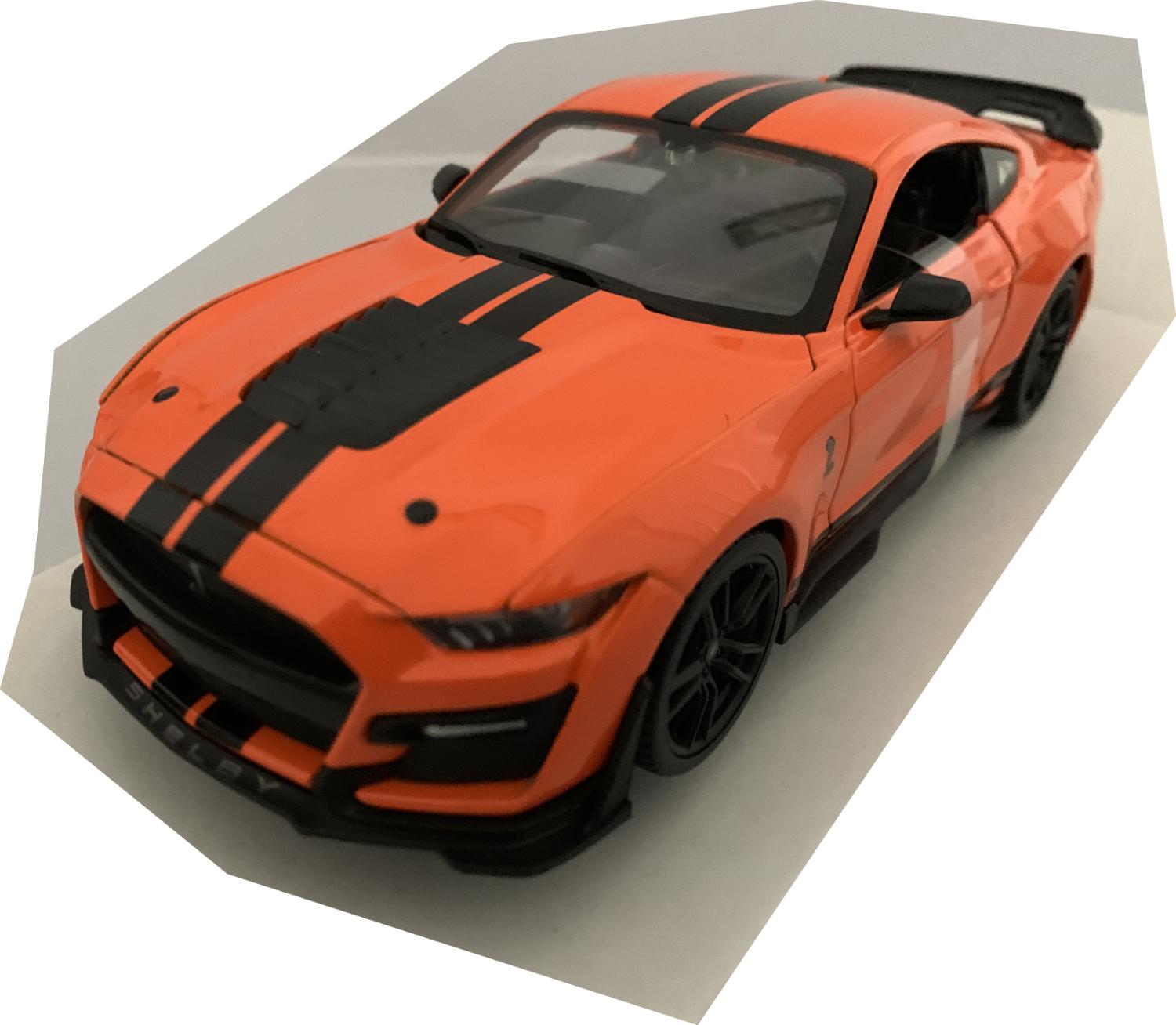 An excellent scale model of a Ford Mustang Shelby GT500 decorated in orange with authentic graphics, rear spoiler and black wheels