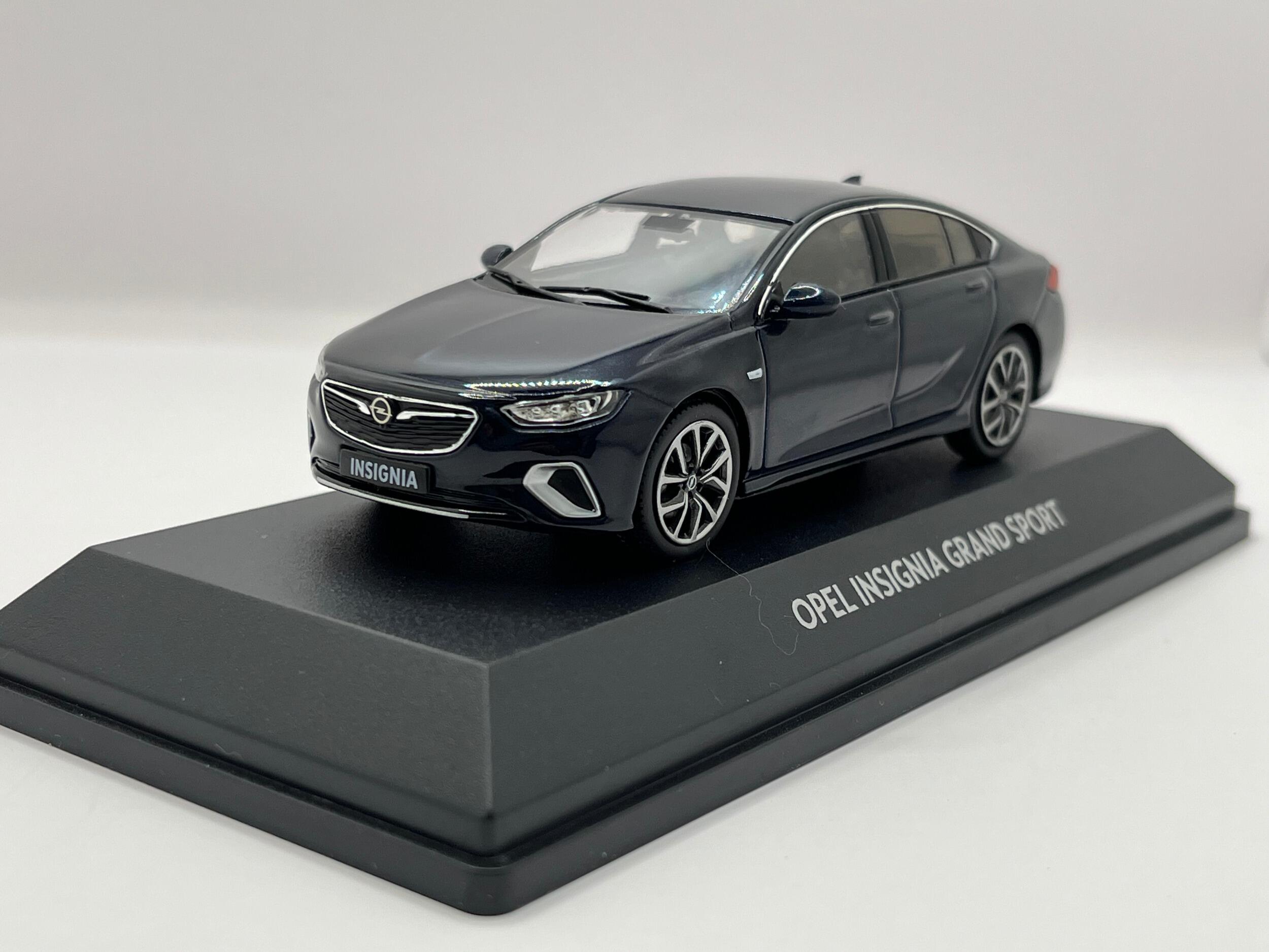An excellent scale model of an Opel (Vauxhall) Insignia Grand Sport decorated in dark blue with silver and black wheels.  Other trims are finished in chrome, silver and black.