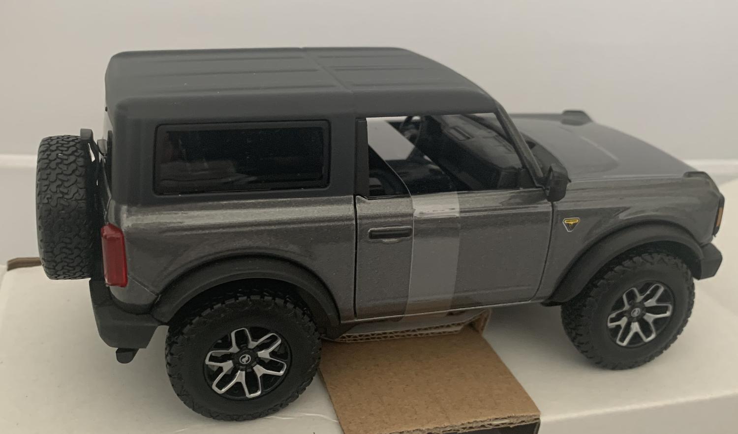 An excellent scale model of a Ford Bronco Badlands decorated in grey and black roof with silver and black wheels