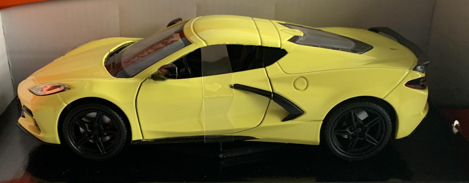 An excellent scale model of a Chevrolet Corvette C8 decorated in yellow with black wheels, side air vents and rear spoiler