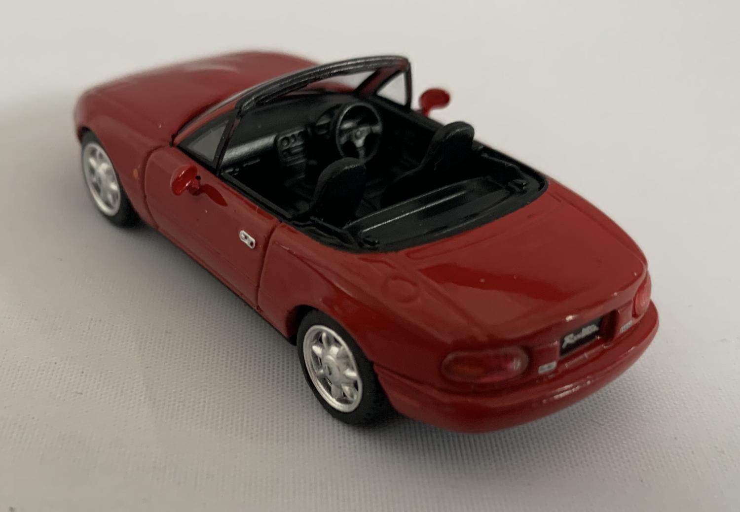 An excellent scale model of a Eunos Roadster decorated in classic red with silver wheels.