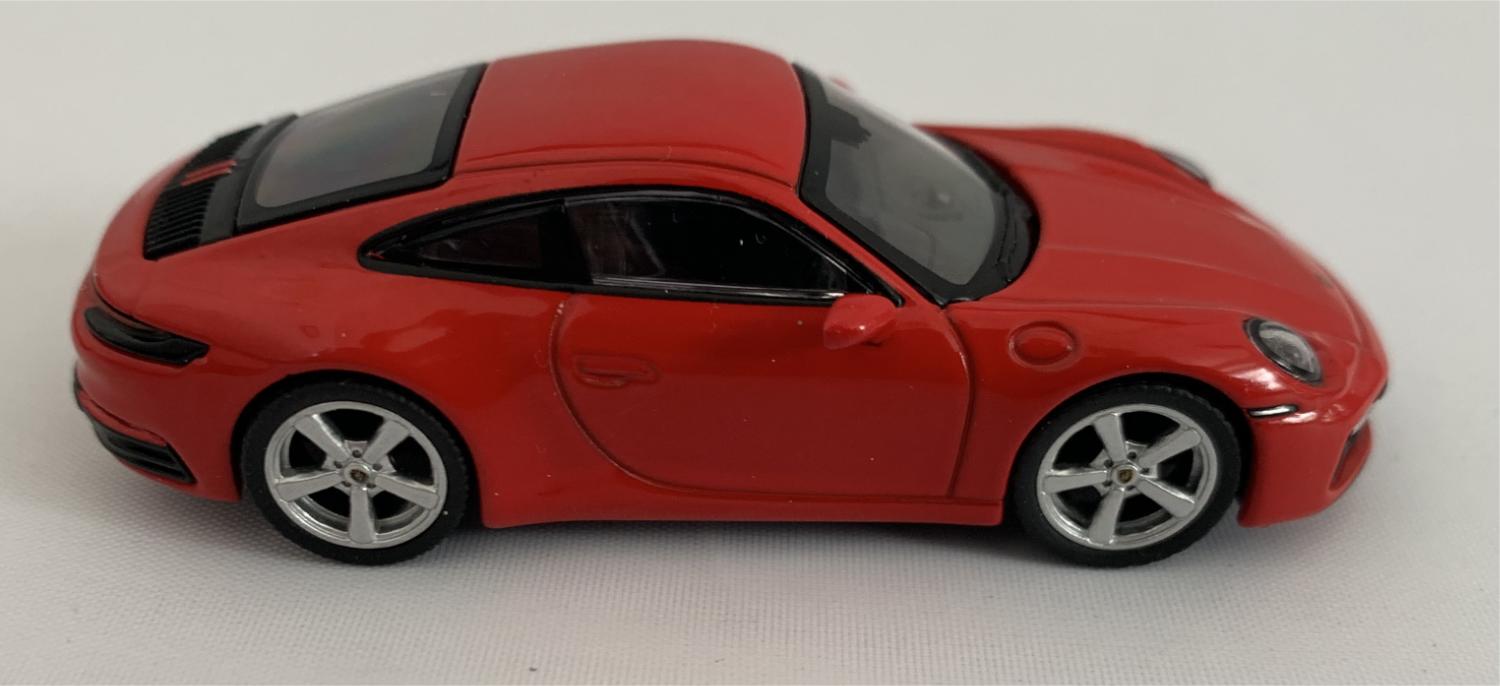 An excellent scale model of a Porsche 911 Carrera S decorated in guards red with silver wheels.