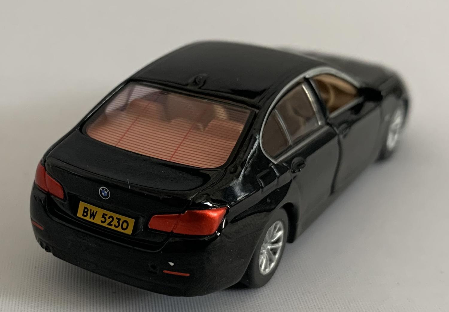 BMW 5 Series (F10) in black 1:64 scale model from Tiny
