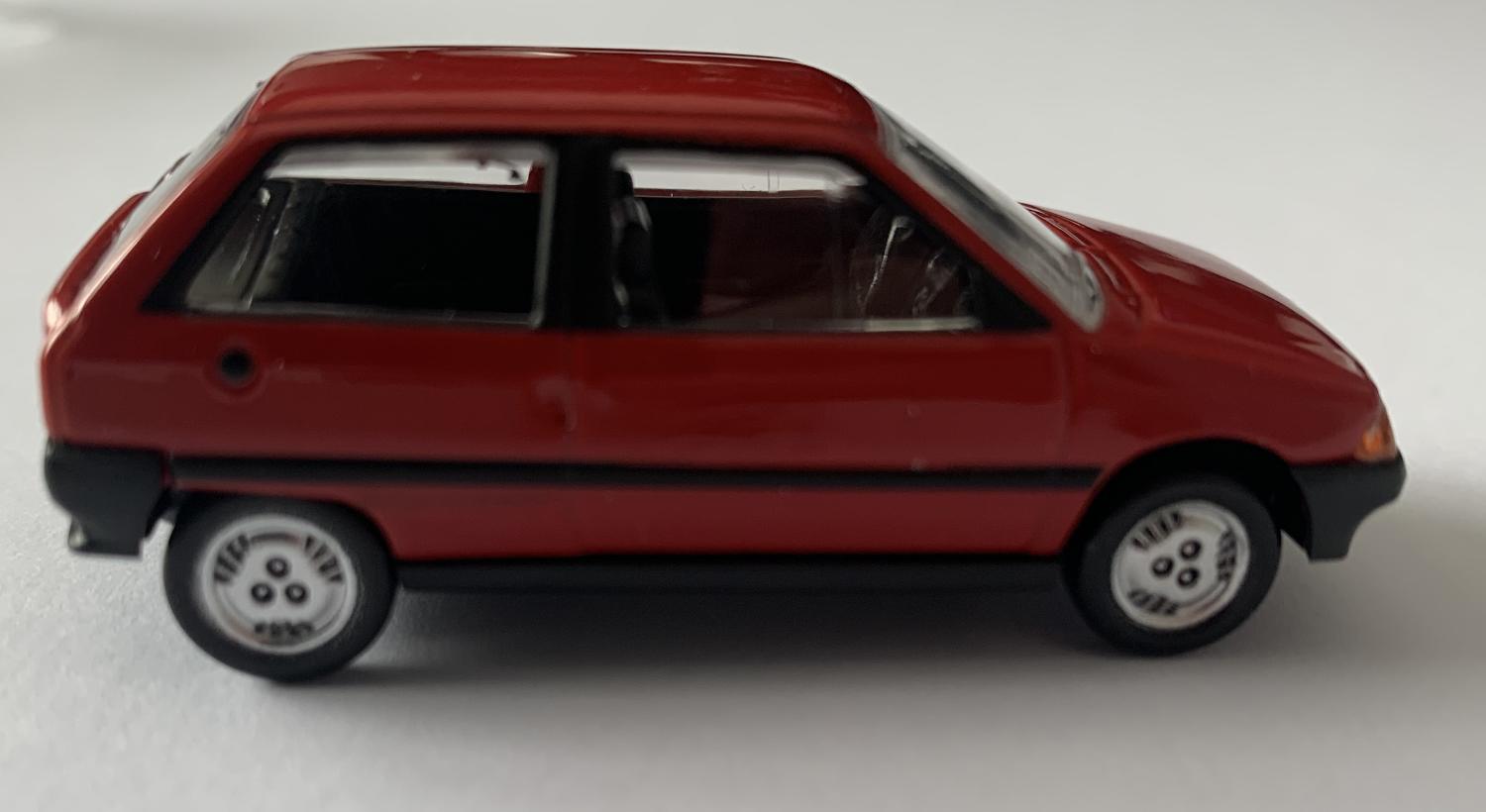 A good reproduction of the Citroen AX presented in a window display box