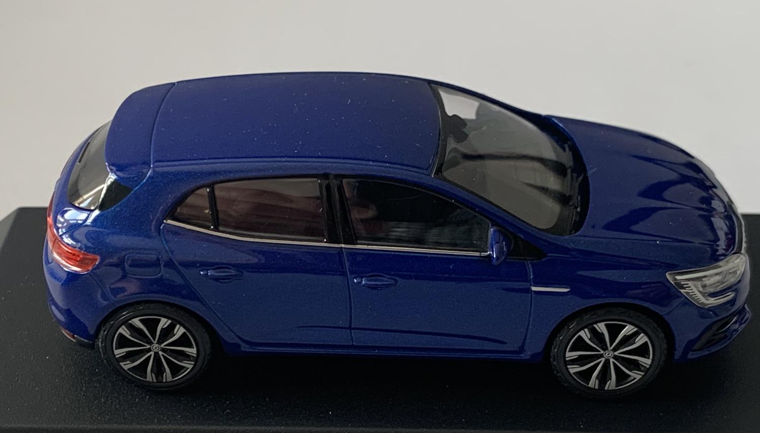 An excellent scale model of a Renault Megane decorated in iron blue with roof top spoiler, tinted windows, black and silver wheels.