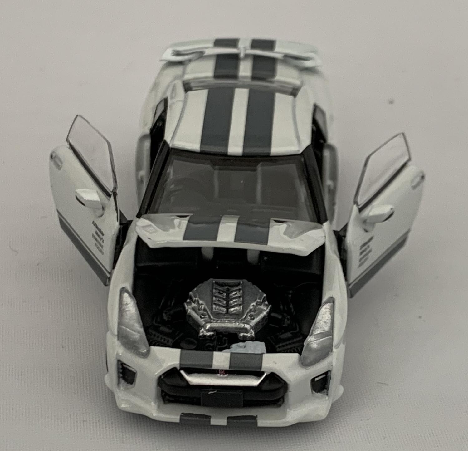 An excellent scale model of a Nissan GT-R (R35) Advan X Sauras by Era Car 56 decorated in white with authentic graphics and rear spoiler.  Other trims are finished in black and silver. Features include opening driver and passenger doors, opening bonnet
