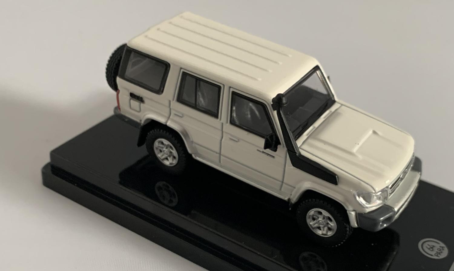 An excellent scale model of a Toyota Land Cruiser decorated in french vanilla with silver wheels,