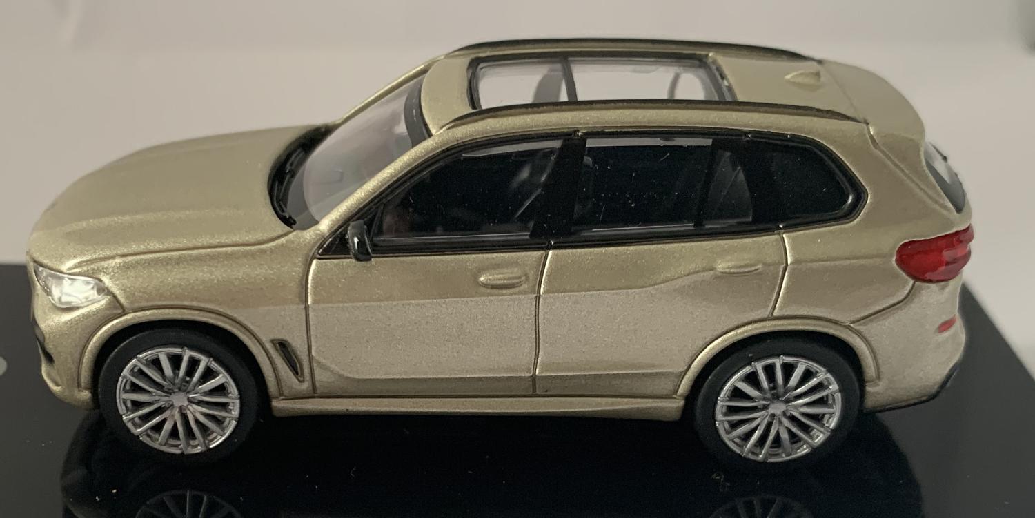An excellent scale model of a 2018 BMW X5 decorated in sunstone metallic with panoramic roof, roof rails