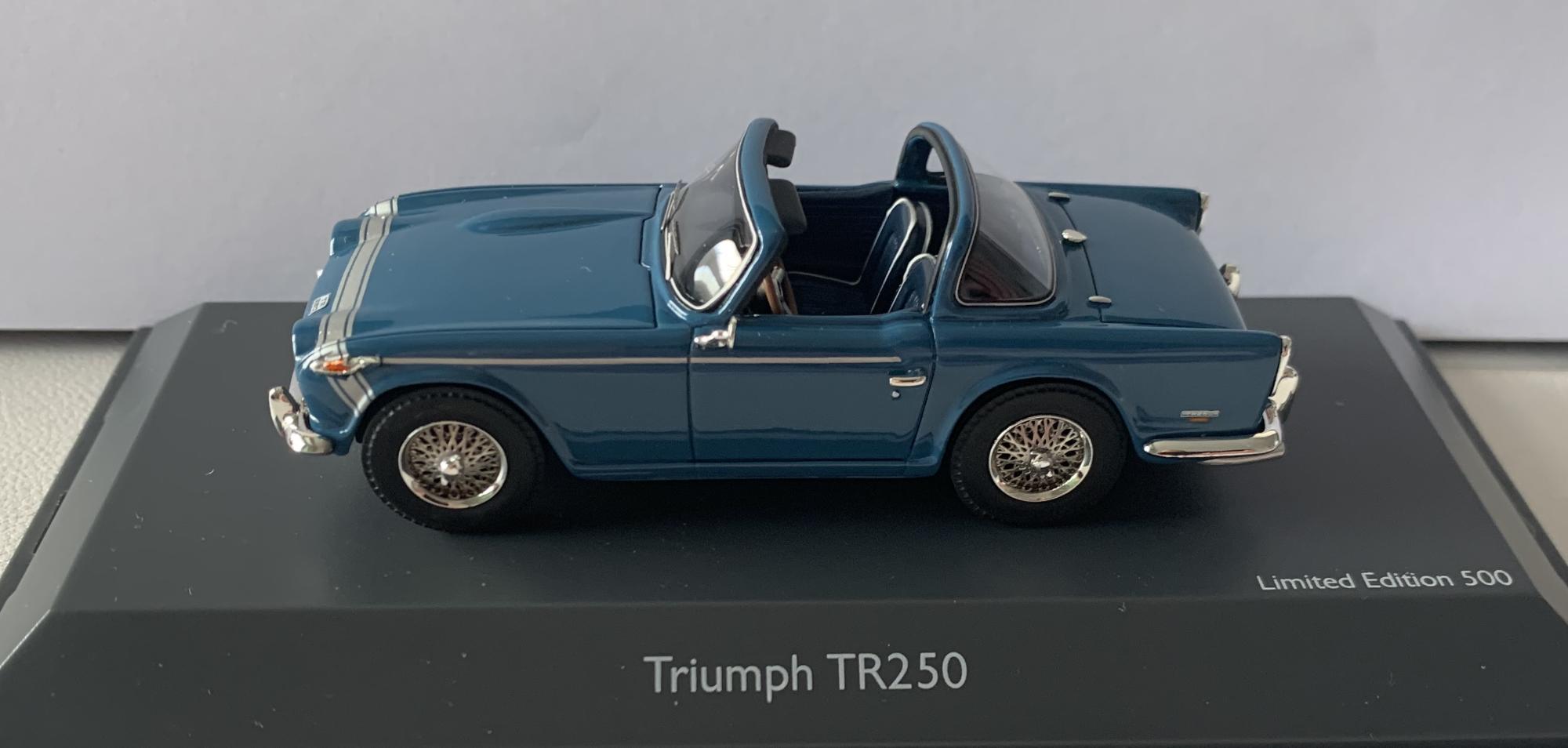 A very highly detailed scale model of a Triumph TR250 decorated in blue with silver trim to front bonnet and wired working wheels. Lots of chrome finishing to bumpers, door mirrors