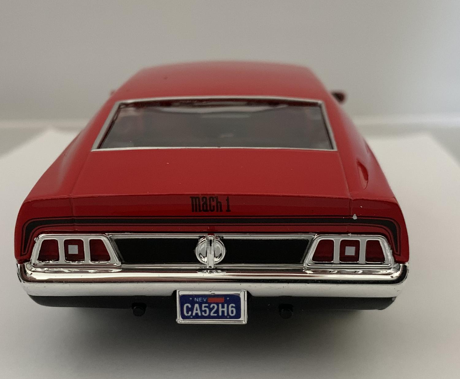 An excellent scale model of a Ford Mustang Mach 1 in red with authentic graphics, bonnet air vents and chrome wheels.