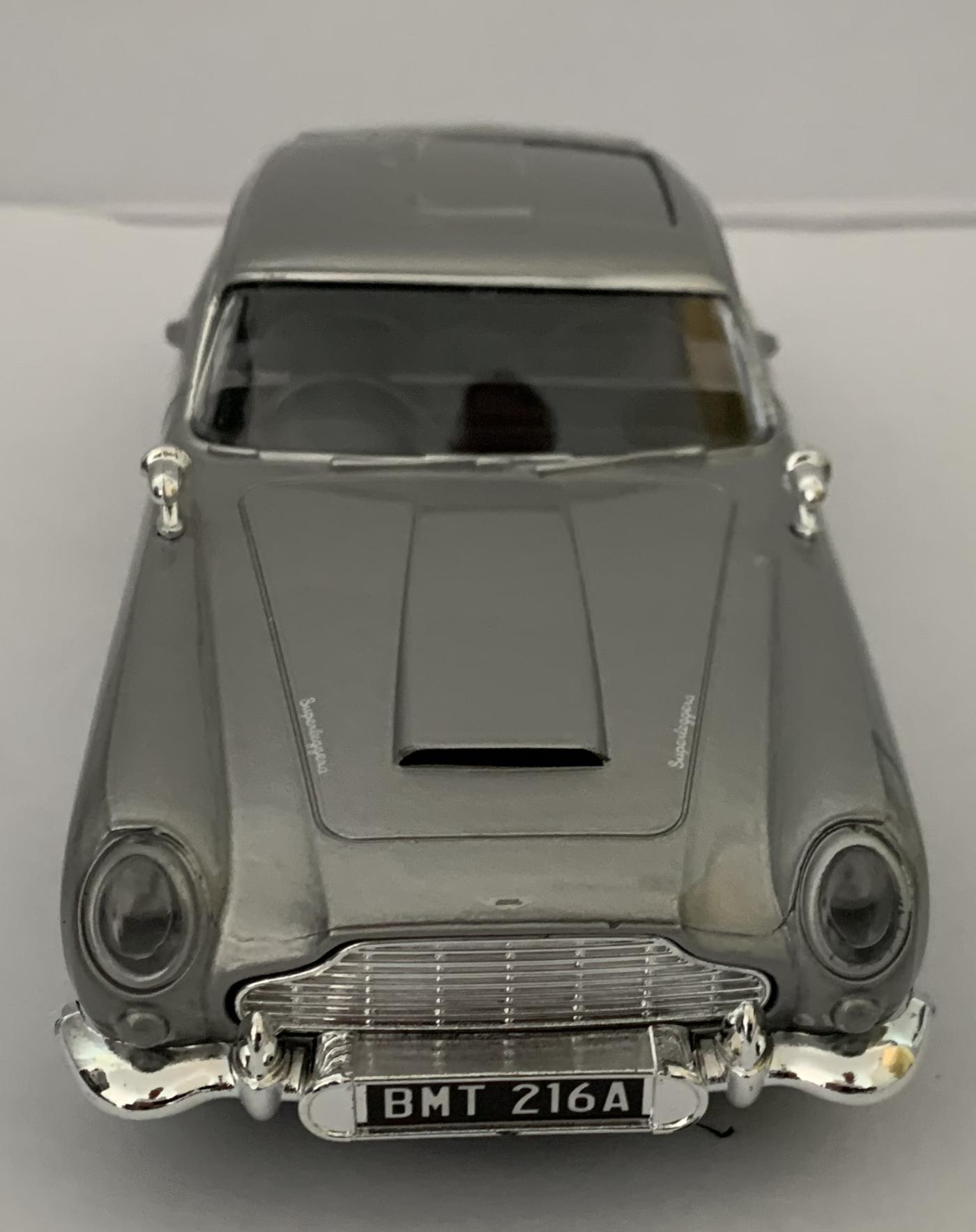 An excellent scale model of an Aston Martin in silver with side air vents and wired chrome wheels.