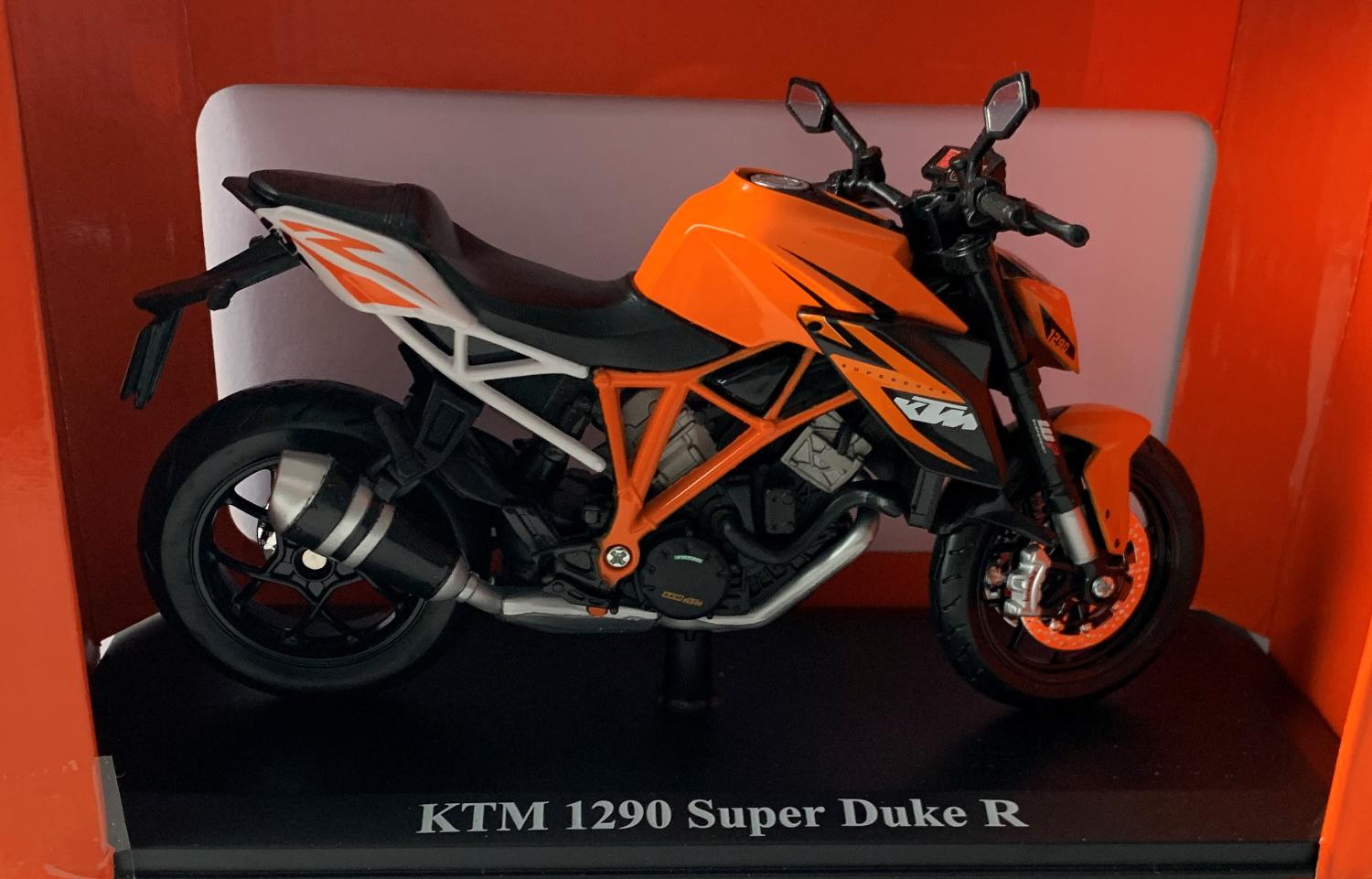 KTM 1290 Super Duke R in orange / black 1:12 scale model from Maisto , mounted on a plinth and presented in orange KTM themed box.