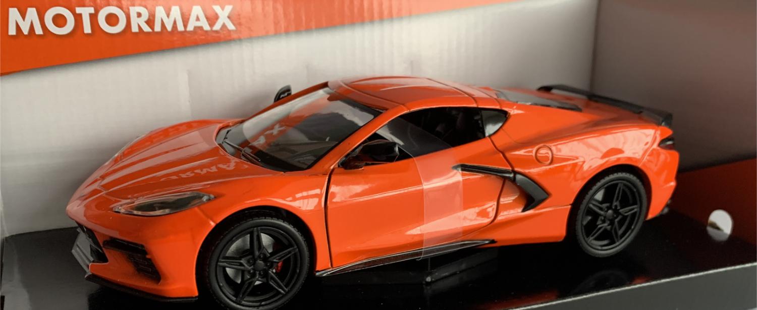 An excellent scale model of a Chevrolet Corvette C8 decorated in orange with black wheels, side air vents and rear spoiler