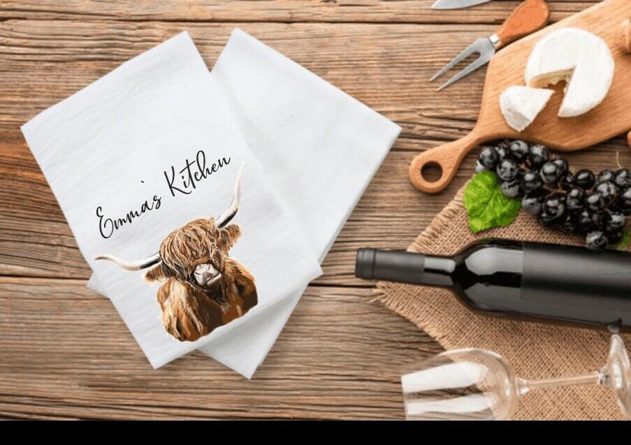 Personalised teatowel with an illustration of a highland cow from emma metcalf designs
