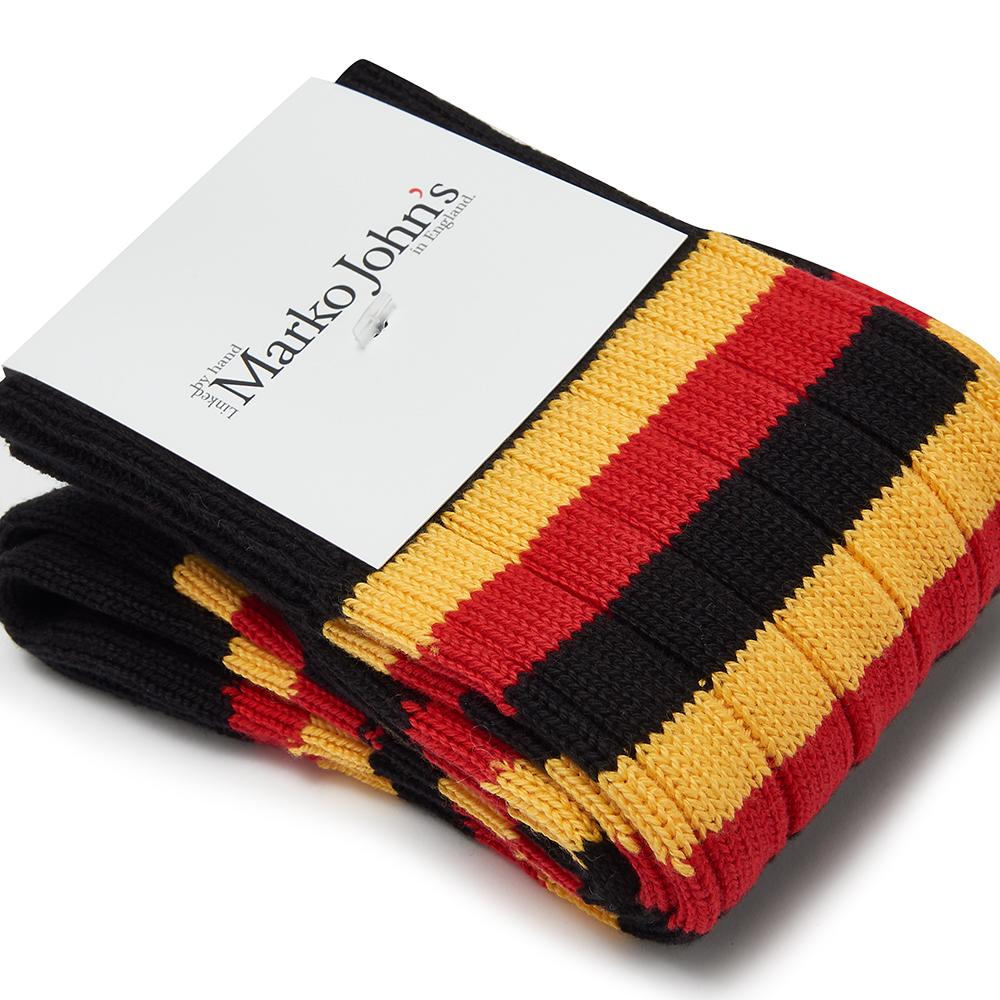 Marko John's Uganda socks in black, yellow, and red stripes