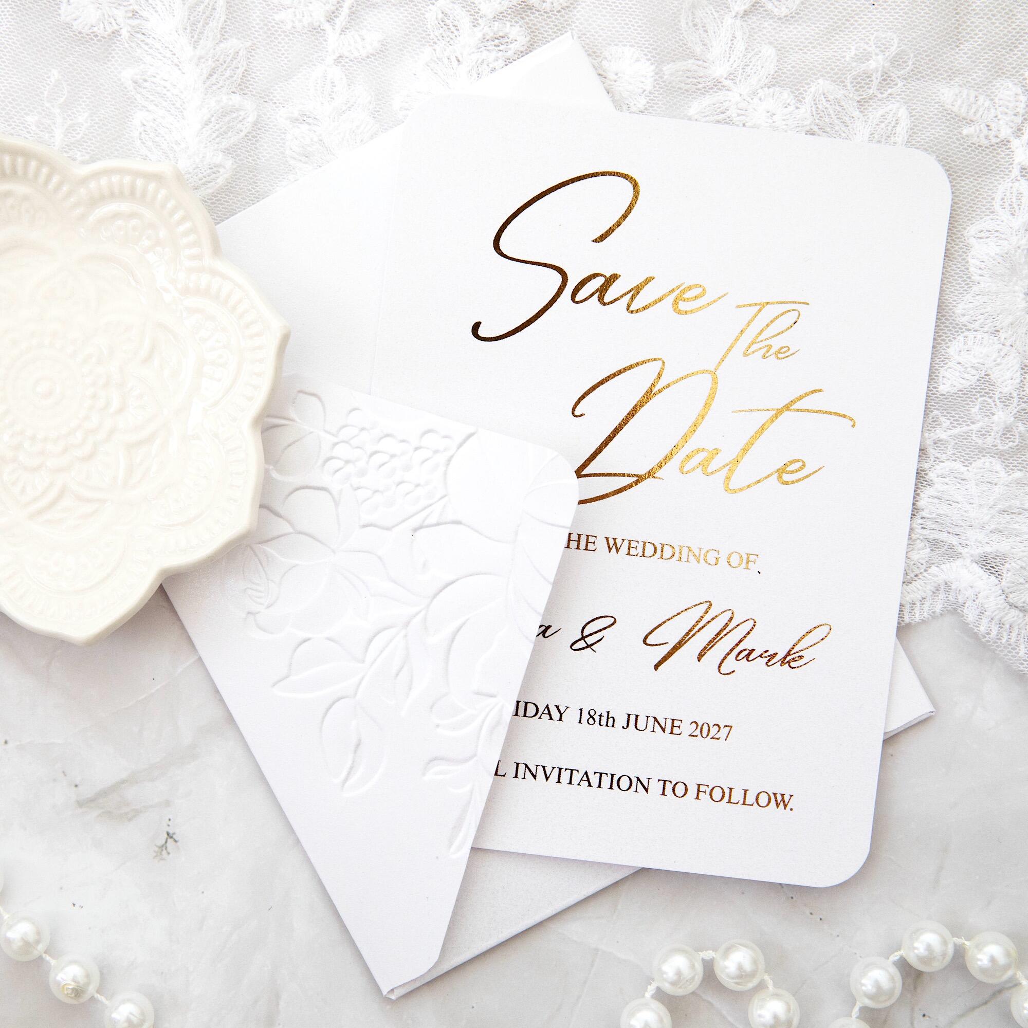 Luxury wedding stationery save the date with gold foil calligraphy and embossed floral envelope, handmade in Leicestershire UK