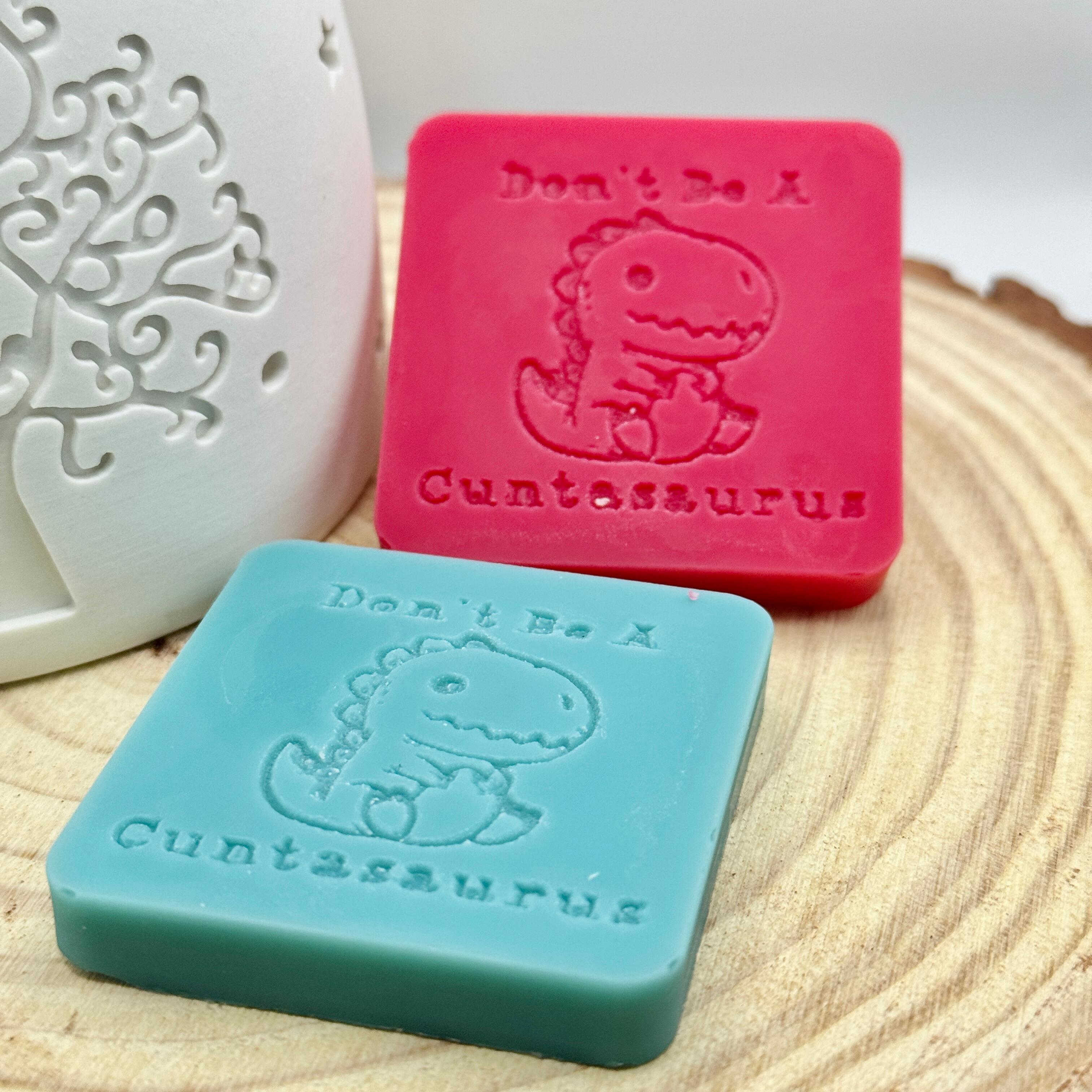 an image of a sweary wax melt square that reads cuntasaurus
