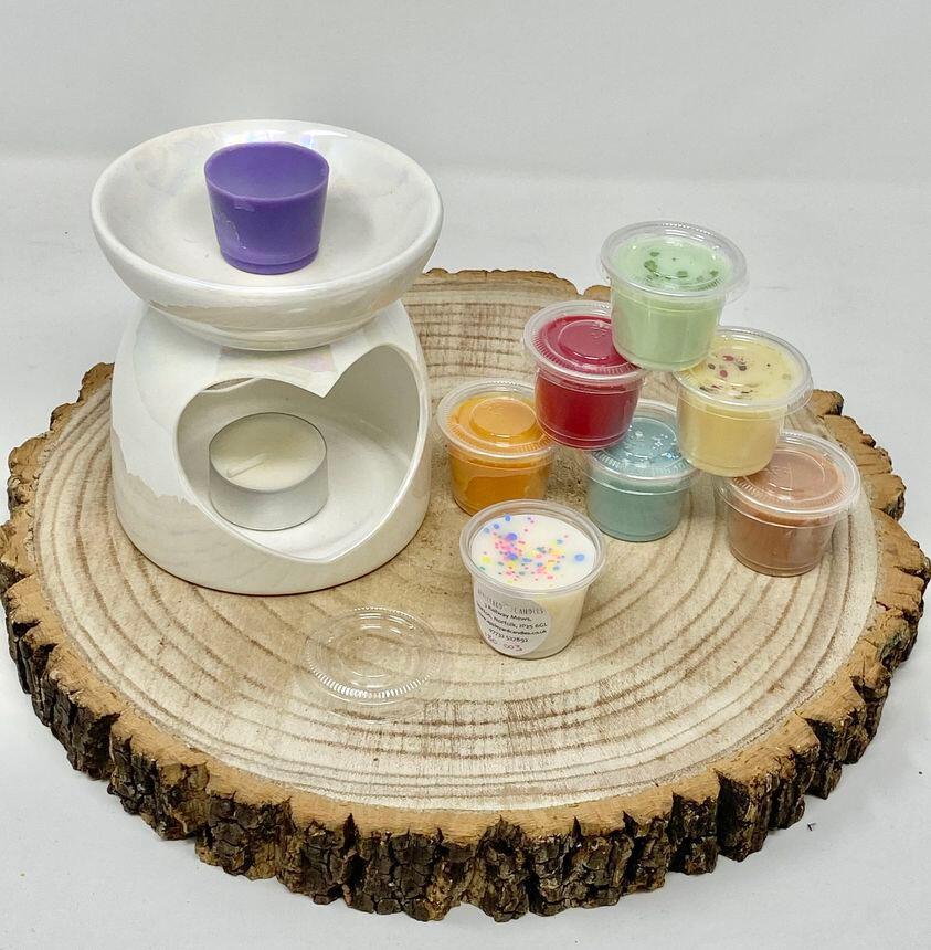 an image of a wax melt burner with several small individual wax melts next to it