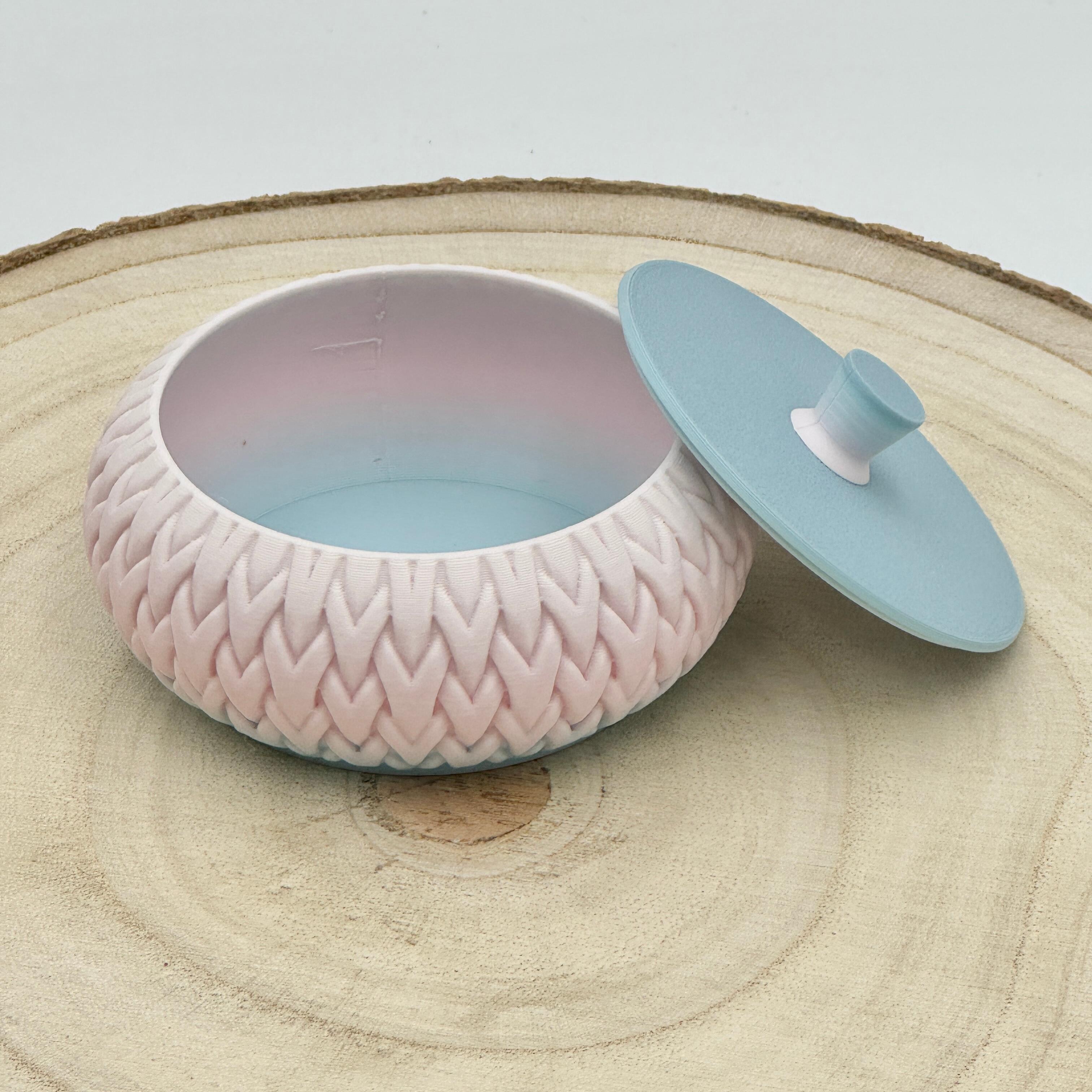 an image of a stackable lidded pot in warm pinks & blues