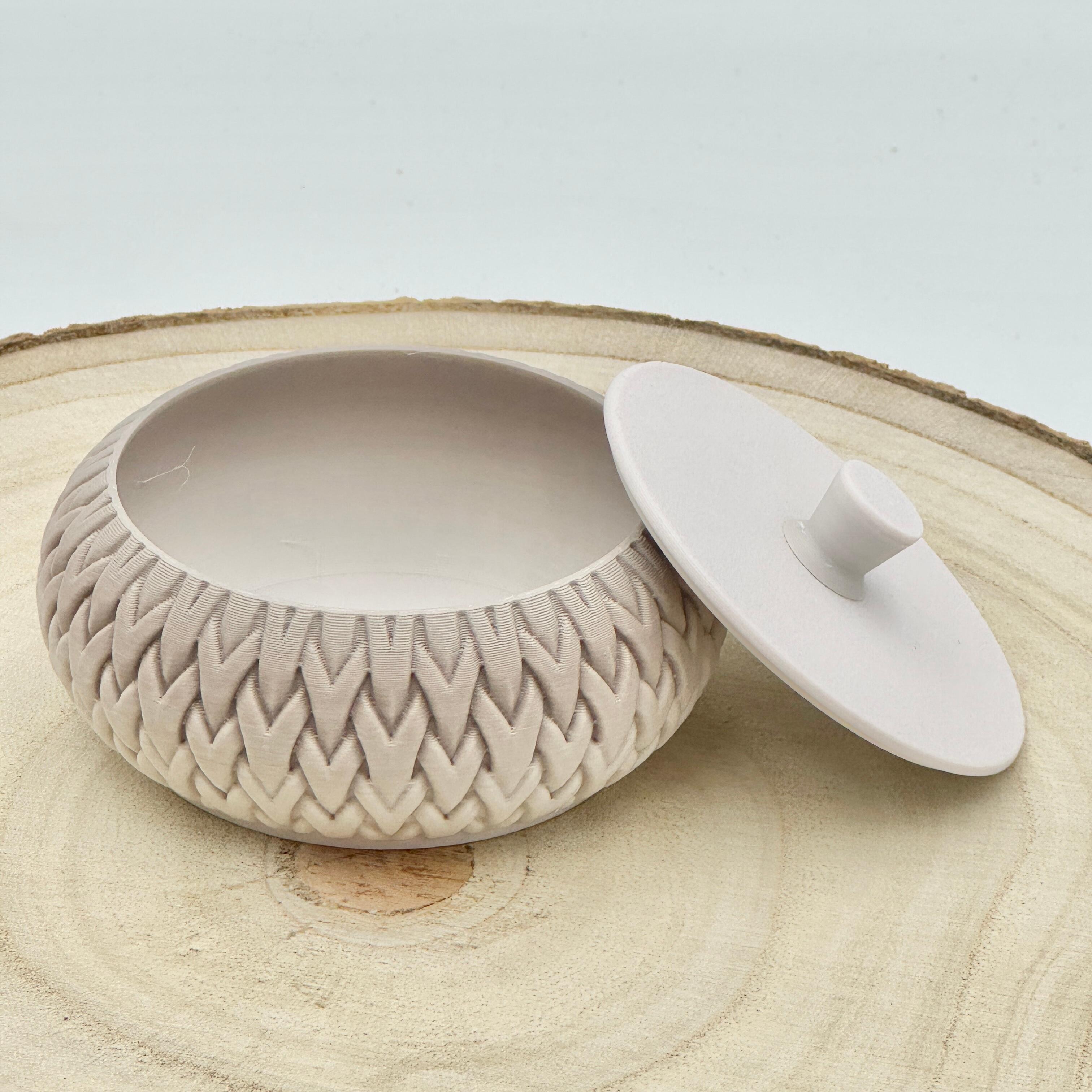 an image of a stackable lidded pot in beige and cream