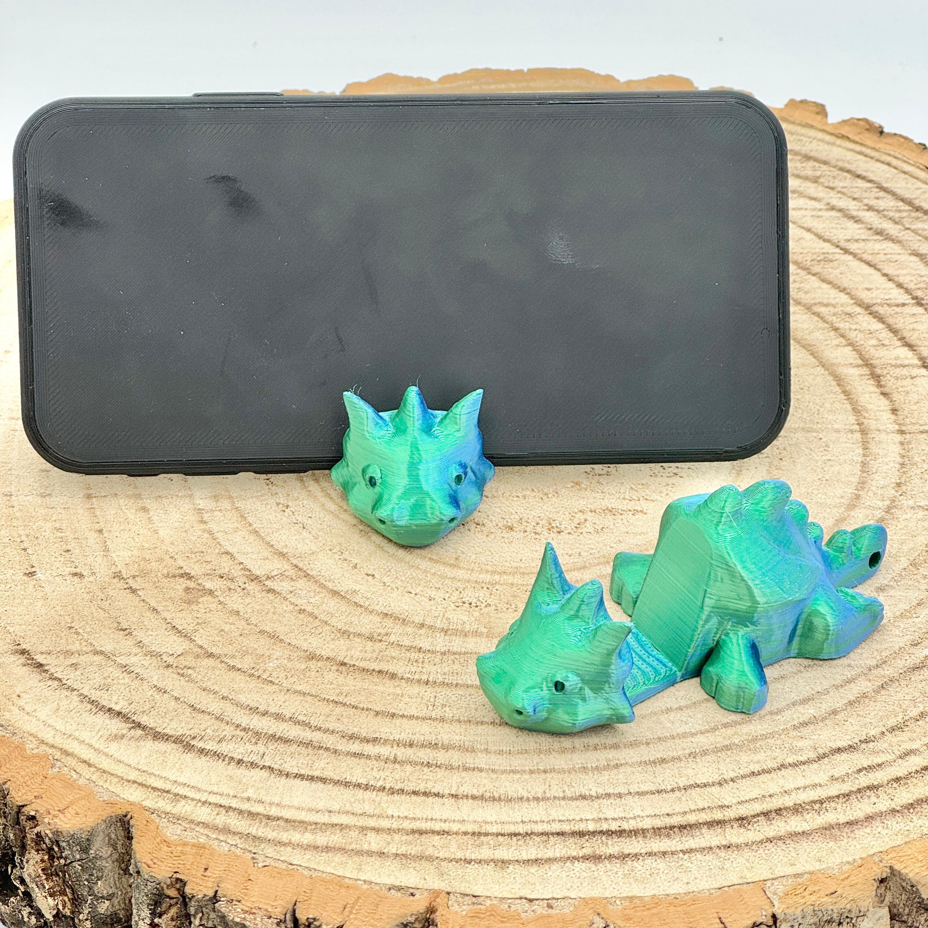 an image of a blue green dragon mobile phone holder