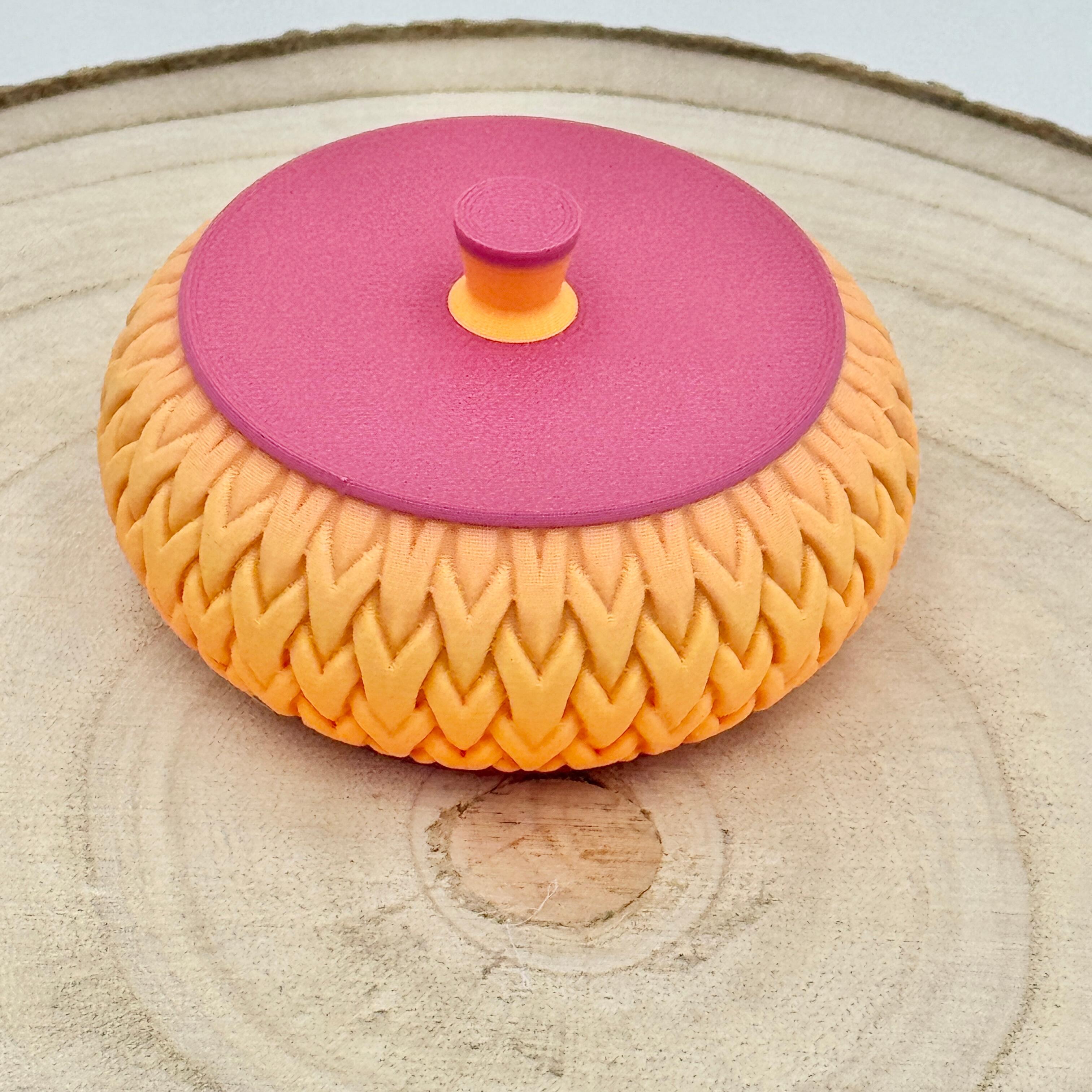 an image of a stackable lidded pot in orange & pink