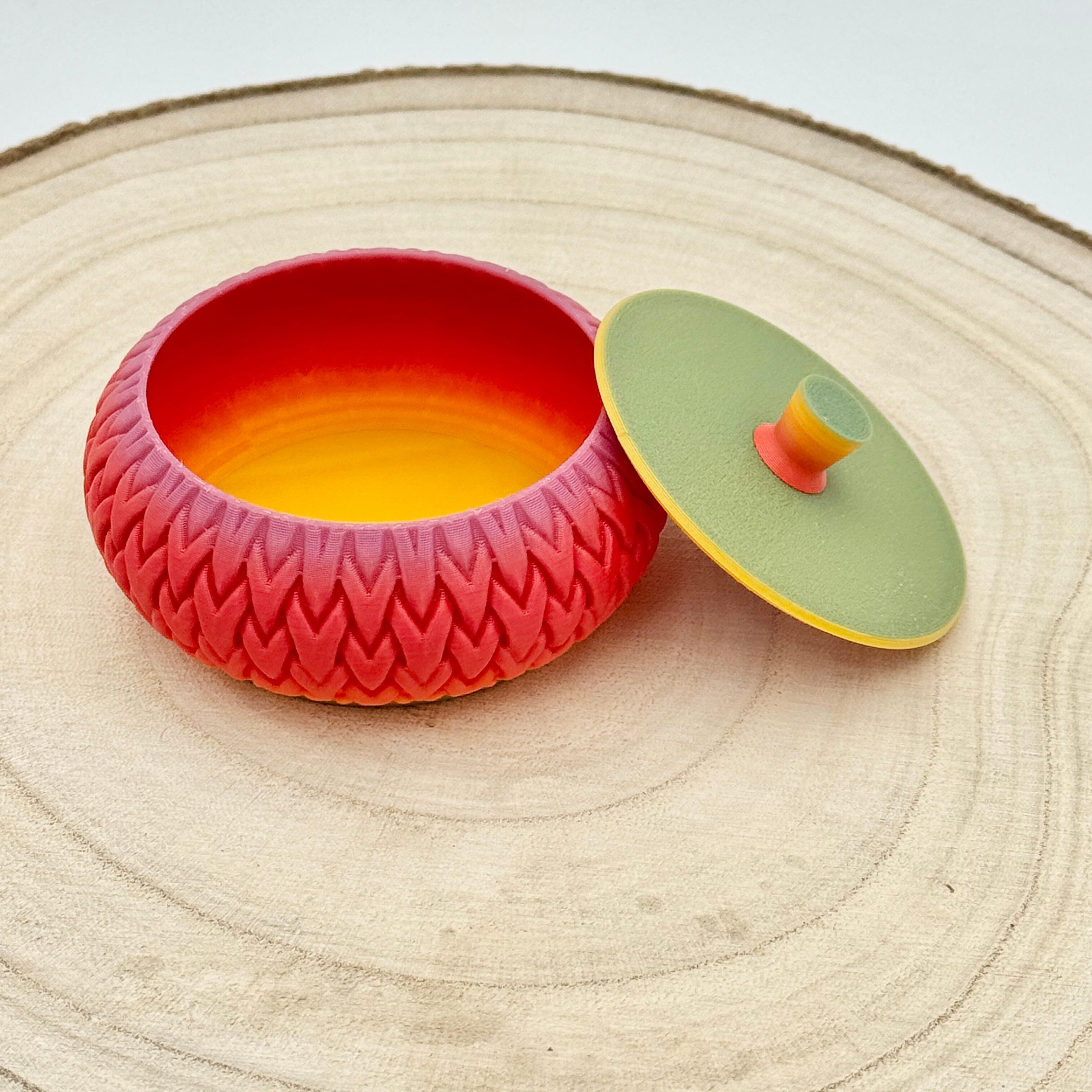 an image of a stackable lidded pot in bold rainbow colours