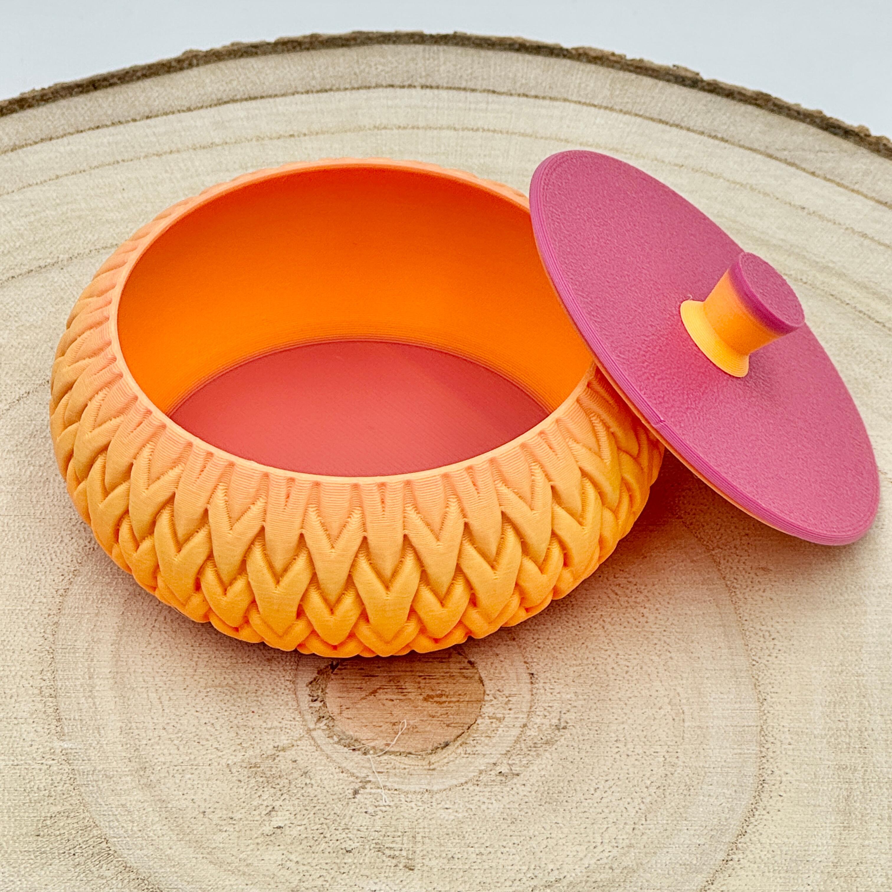 an image of a stackable lidded pot in orange & pink
