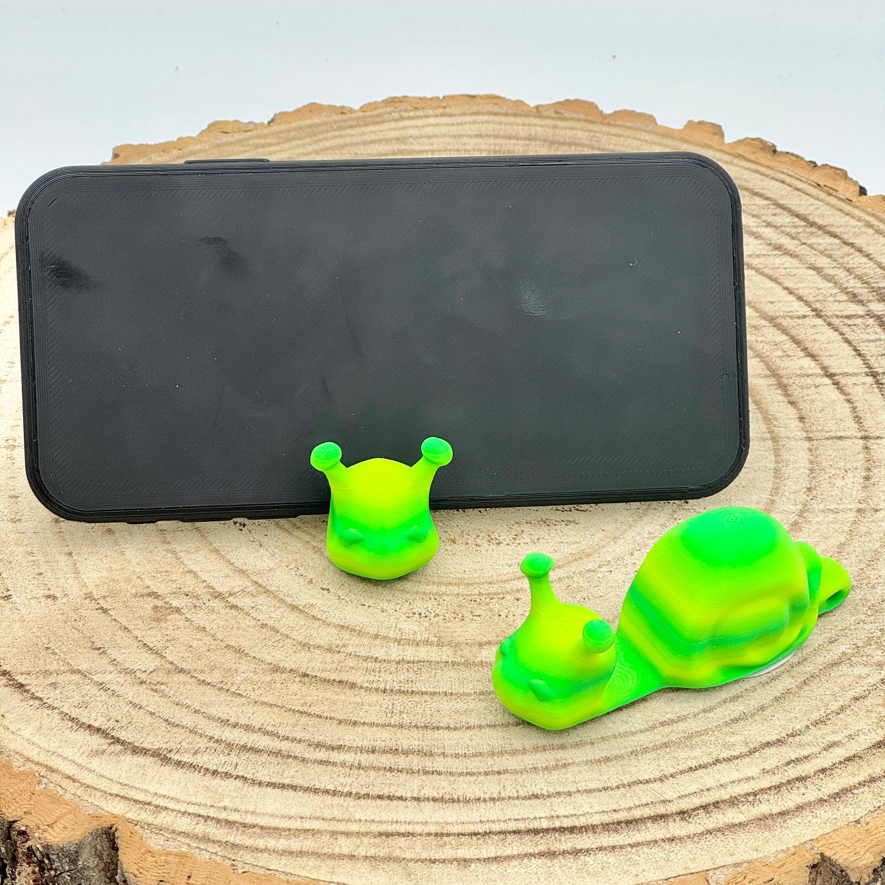 an image of a bright green snail mobile phone holder