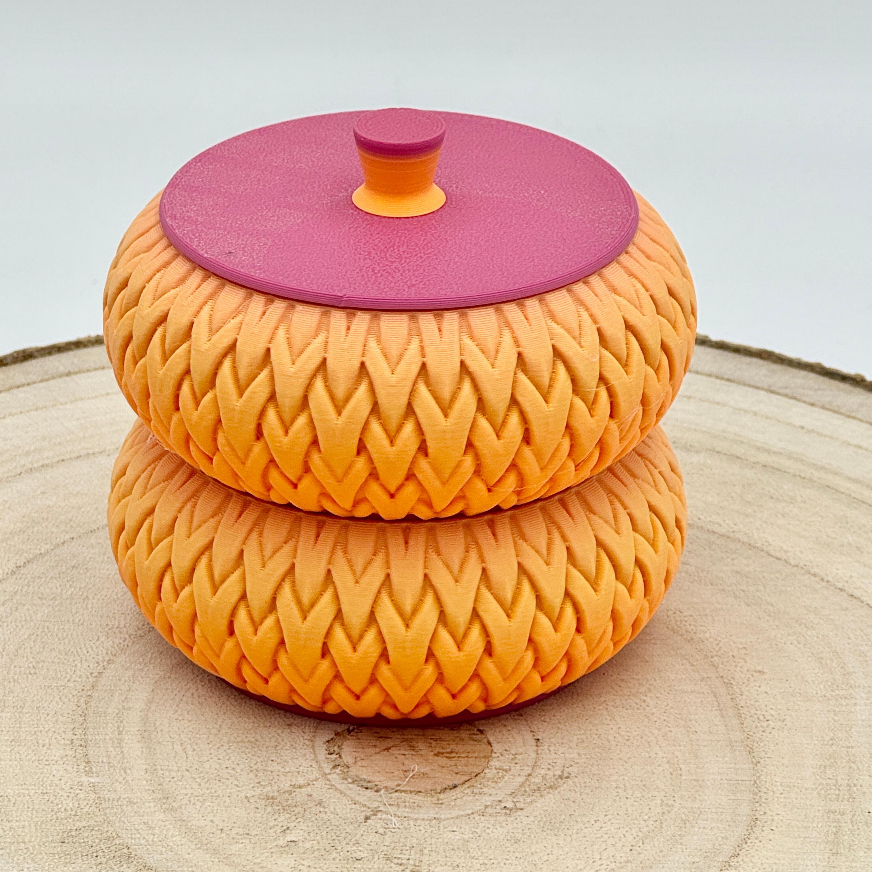 an image of a stackable lidded pot in orange & pink