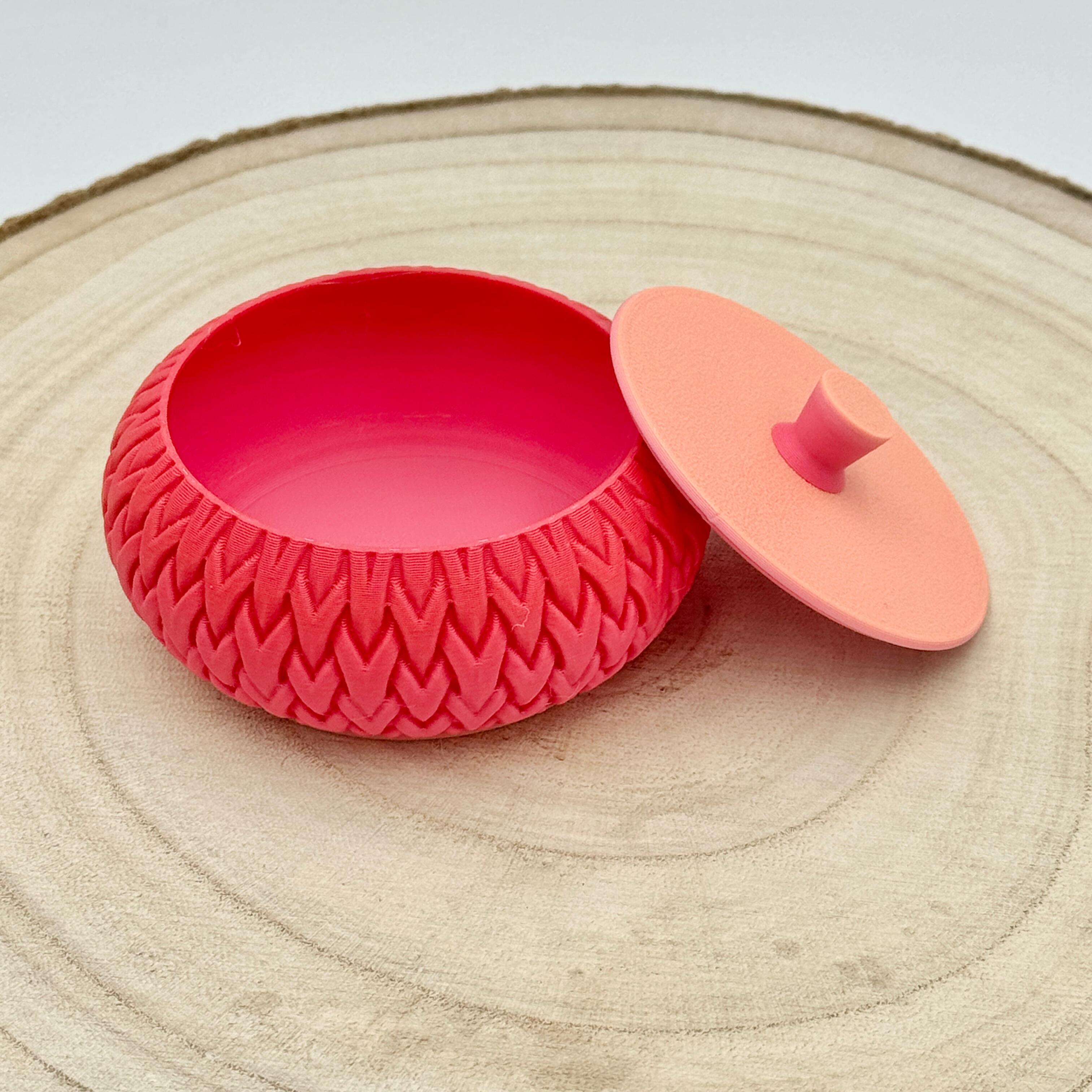 an image of a stackable lidded pot in orange & pink