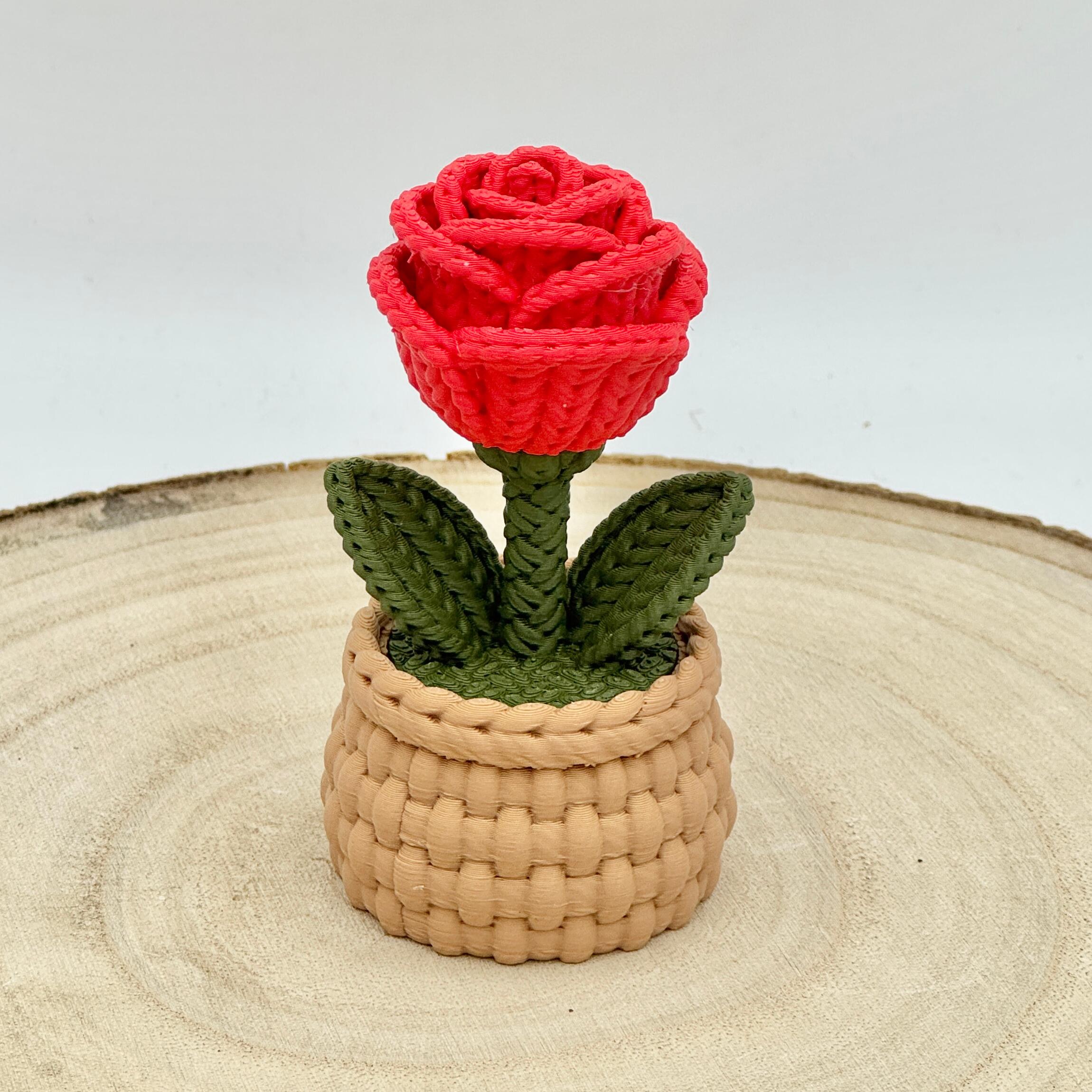red knitted effect roses in a light brown woven basket