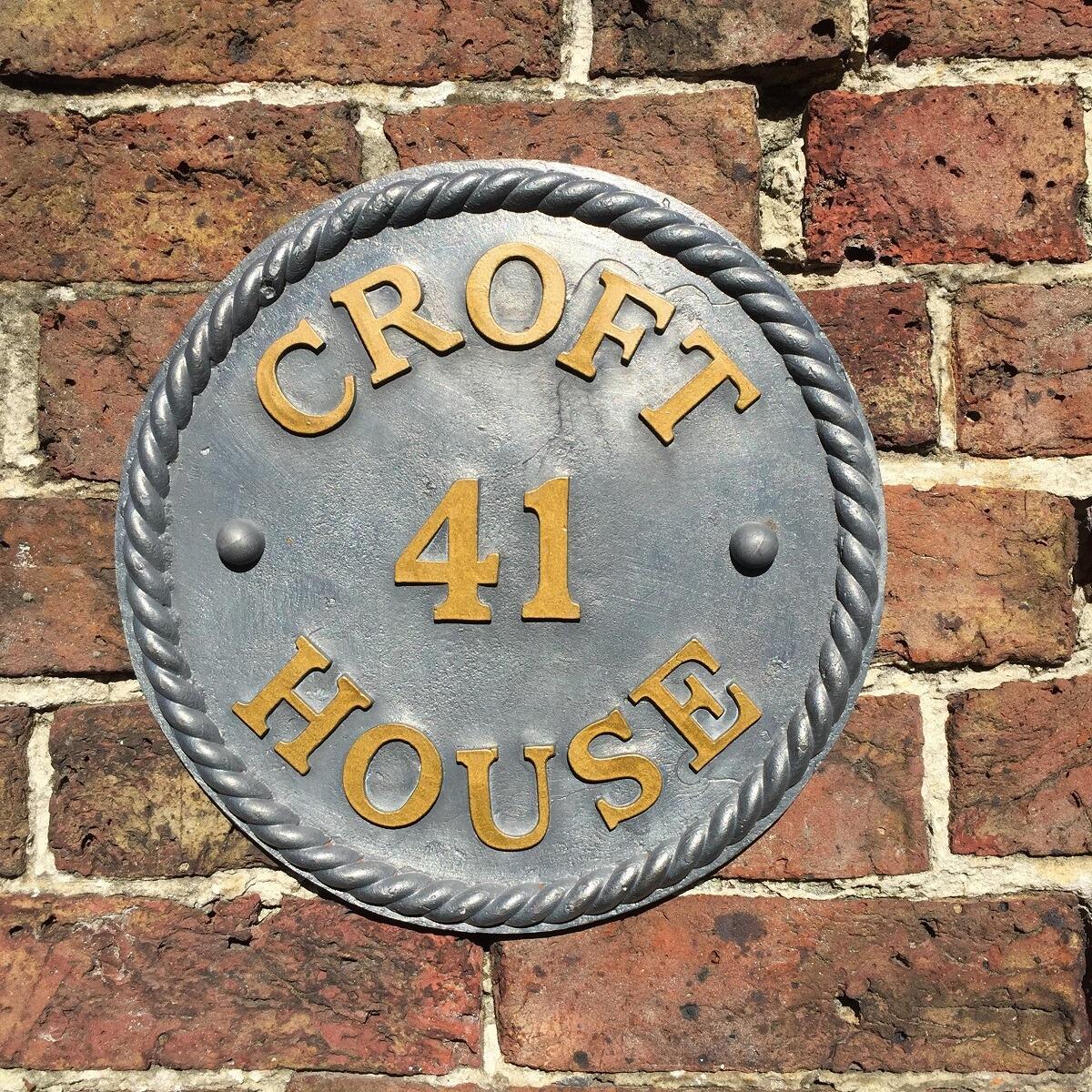Lead round house sign with rope edge