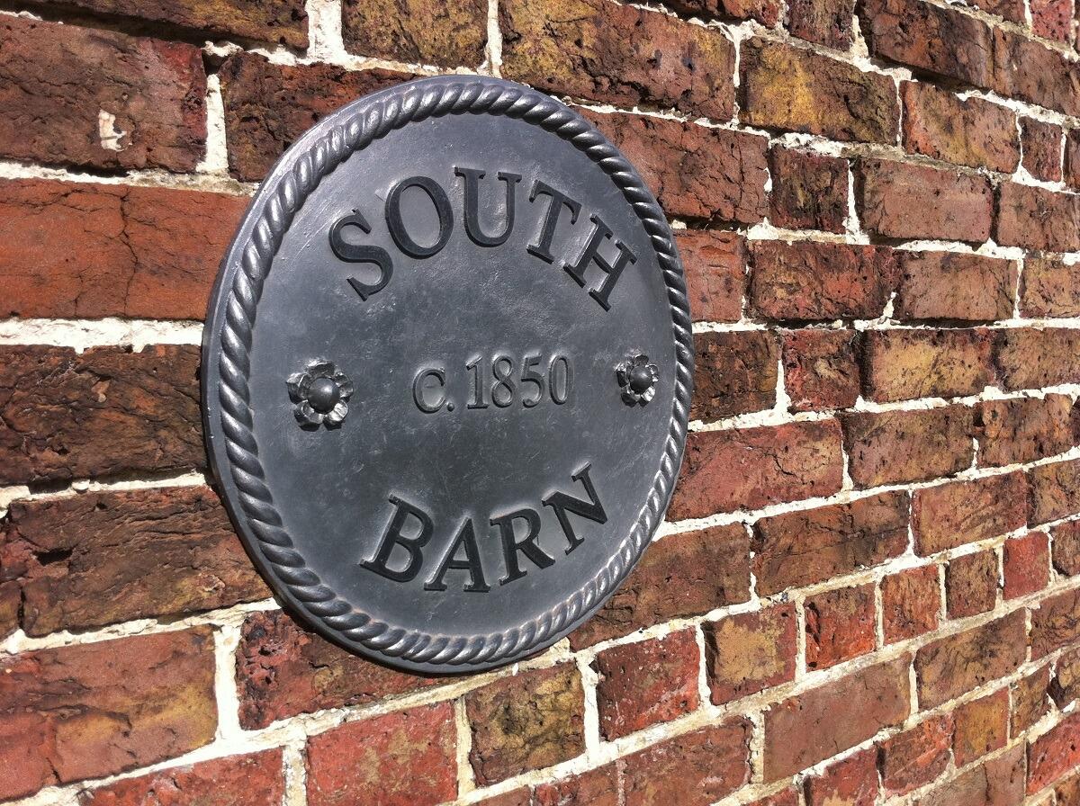 Lead round house sign with rope edge