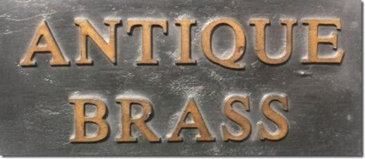 Simple plain lead sign with the word Antique Brass cast painted.