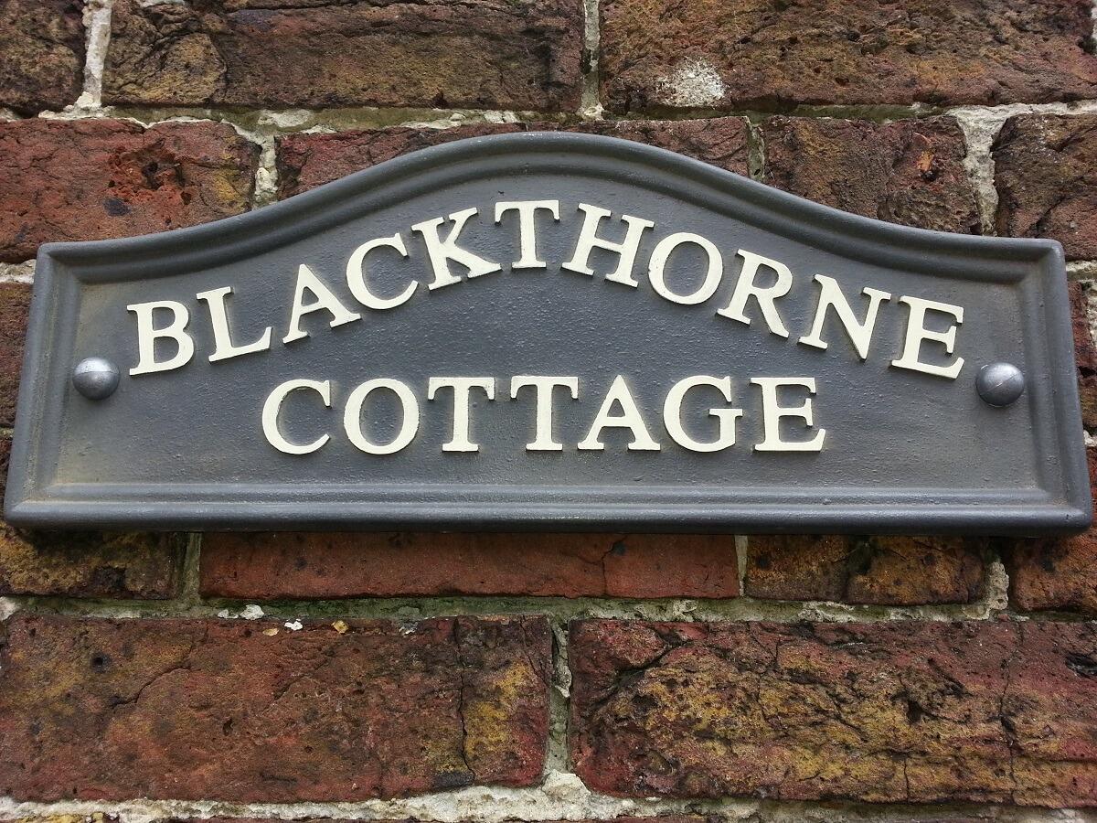 Lead humpback sign with white lettering