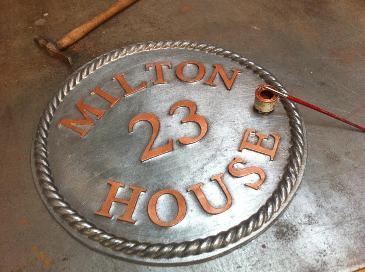 Lead round house sign with rope edge
