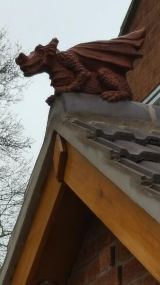 slate grey and brown two tone dragon finial installed on the roof