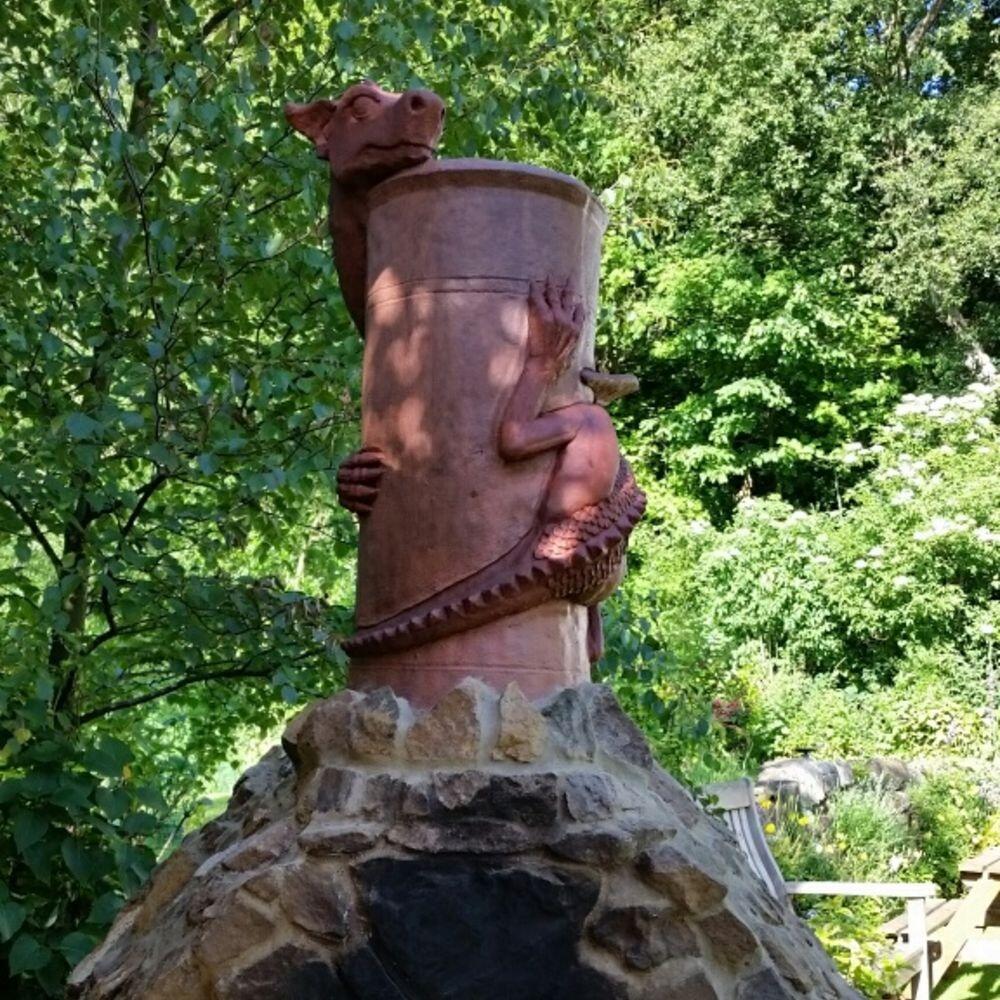 Chimney pot dragon two tone terracotta installed on a pizza oven