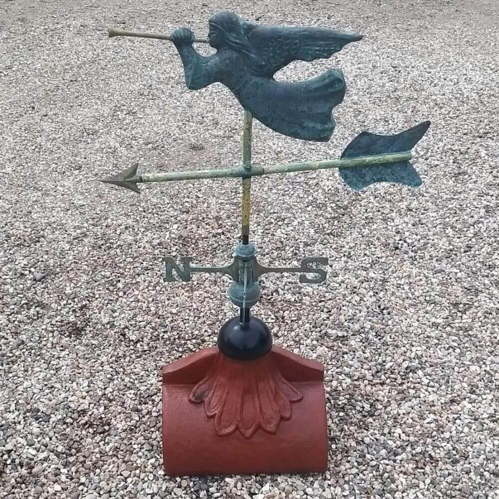 Angel weathervane fitted on a half round roof finial