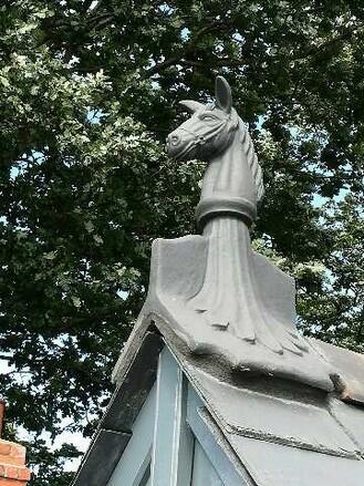 Angled slate grey horse roof finial on roof