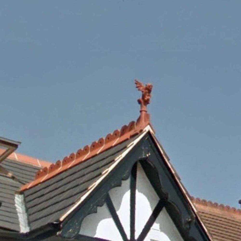 Victorian gargoyle roof finial installed on a gable