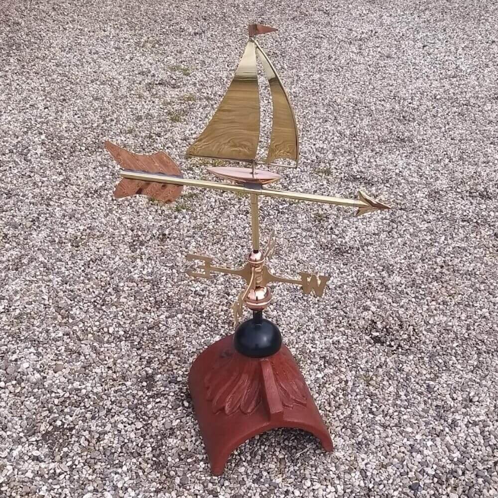 Copper sailboat weathervane fitted to a square ridge tile