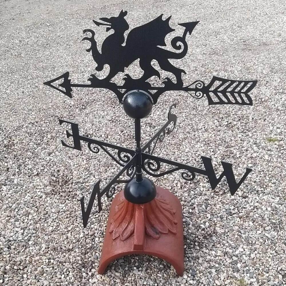 Welsh dragon weathervane mounted on a half round roof tile