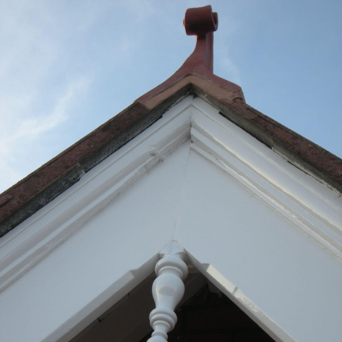 Small swan neck roof finial installed on a gable end