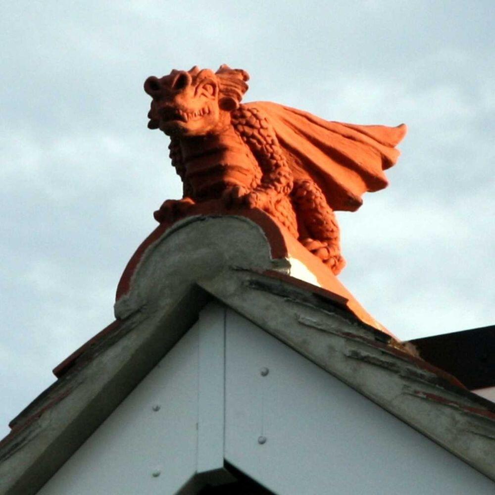Guardian dragon ridge tile finial installed on a roof