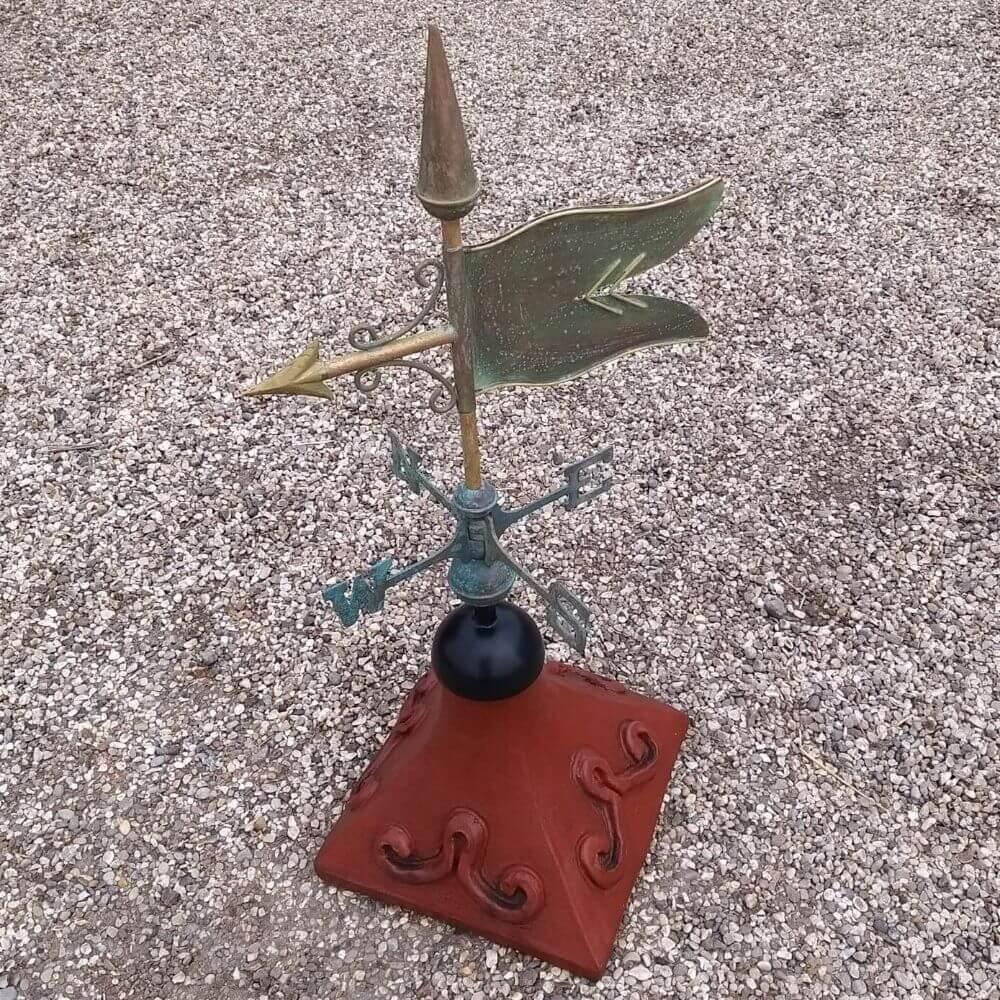 Banner weathervane fixed to a square ridge tile