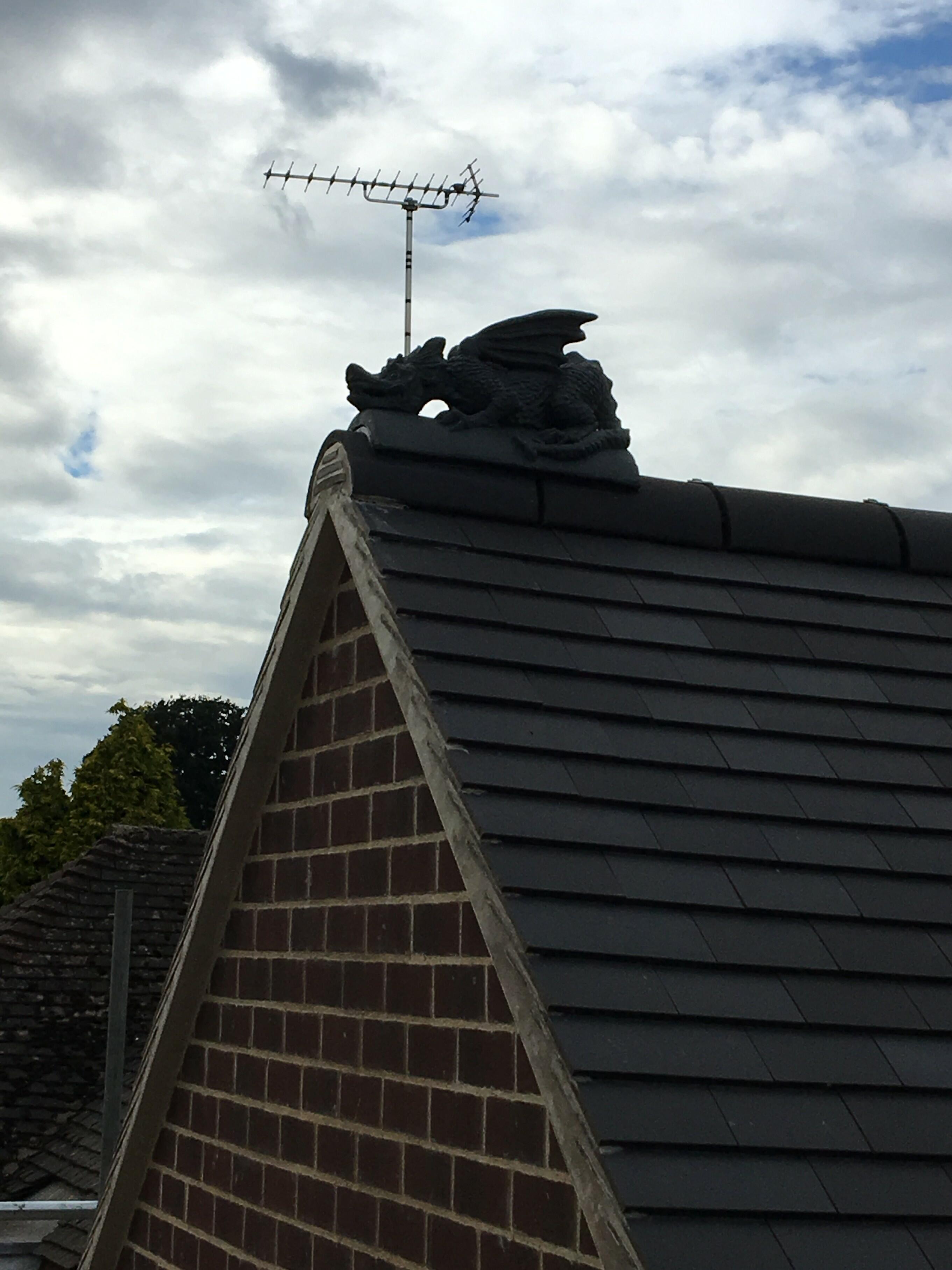 Staffordshire blue colour match dragon finial installed on top of another ridge tile