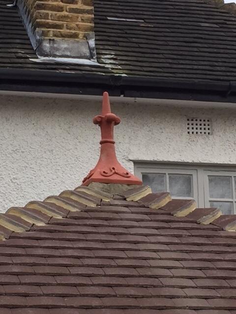 fleur de lys roof finial fitted on a pyramid roof